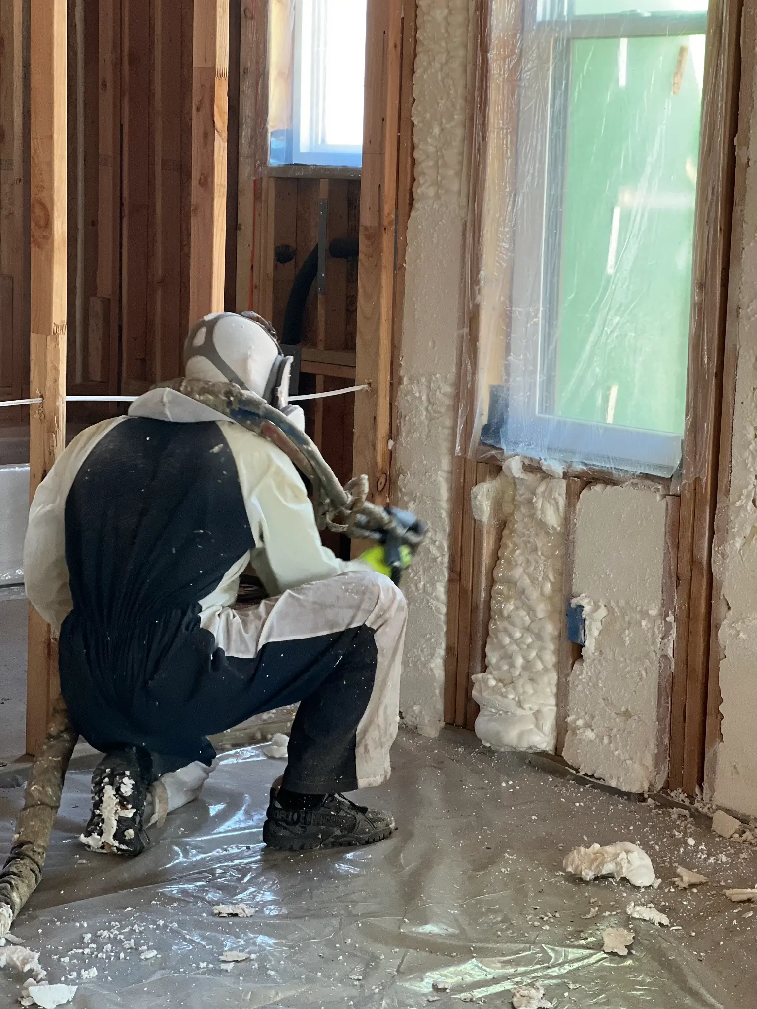 Professional spray foam insulation technician at work